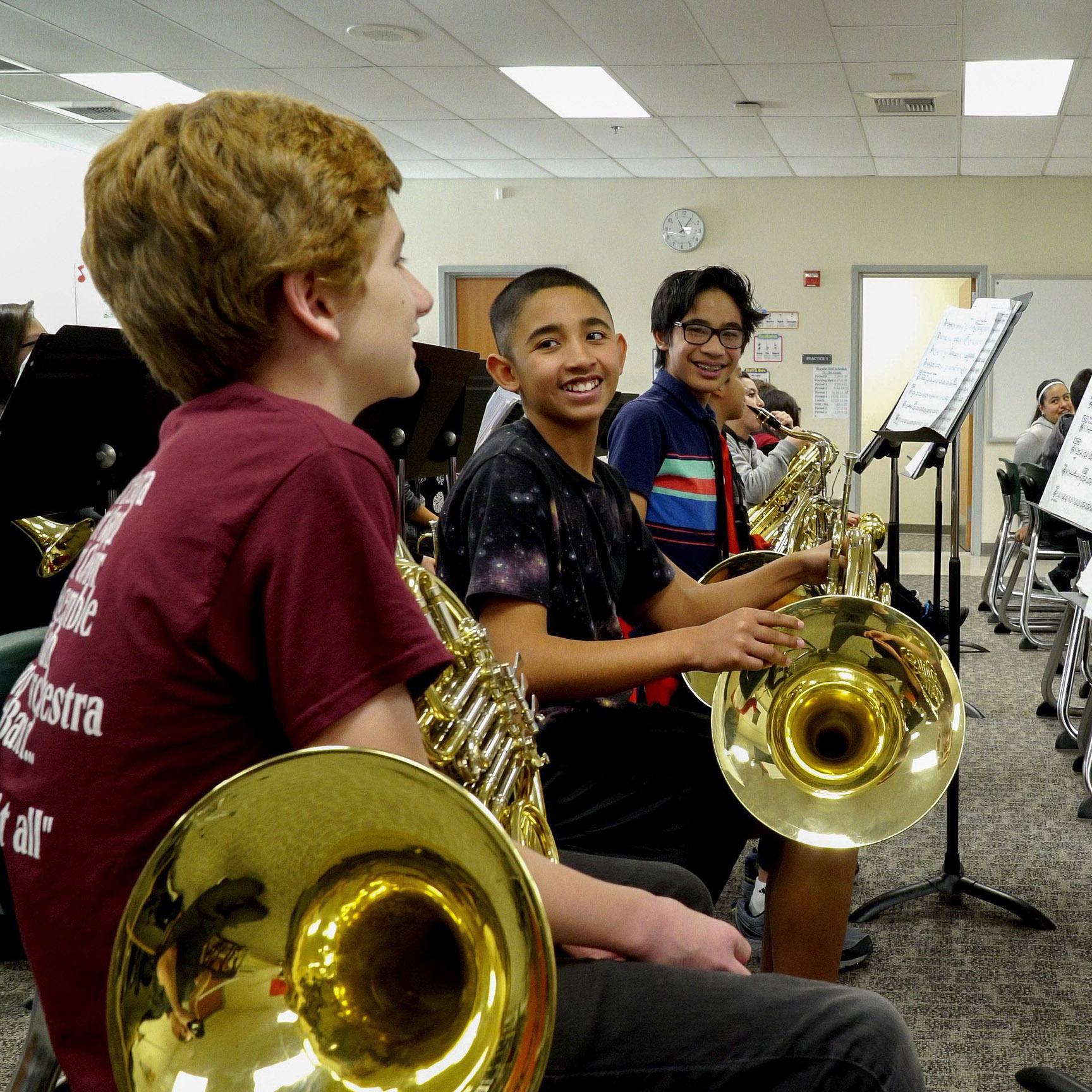 Middle school children playing instruments.