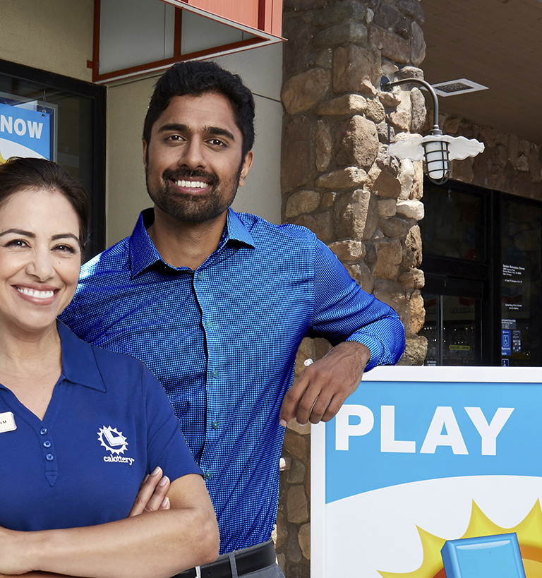 Two California Lottery retailers standing outside of a California Lottery retail store.