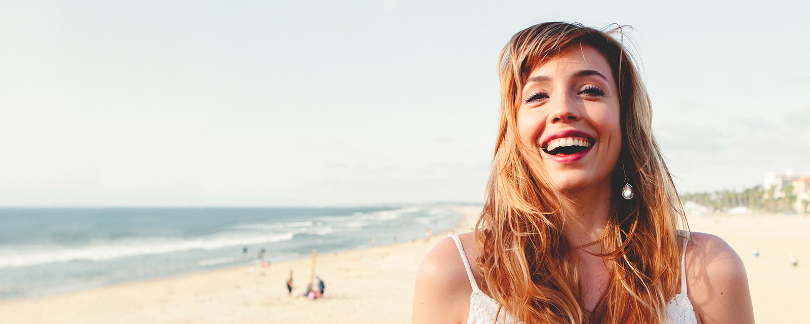 A smiling woman on the beach.