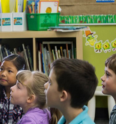 A Teacher reading to young students